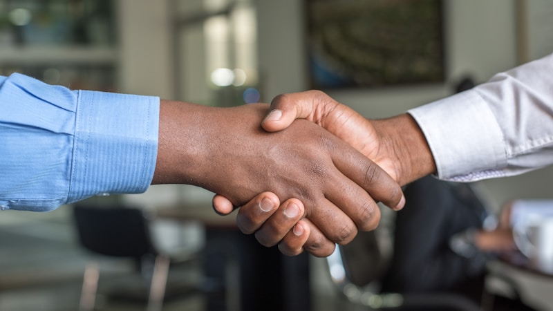Professional handshake after successful salary negotiation